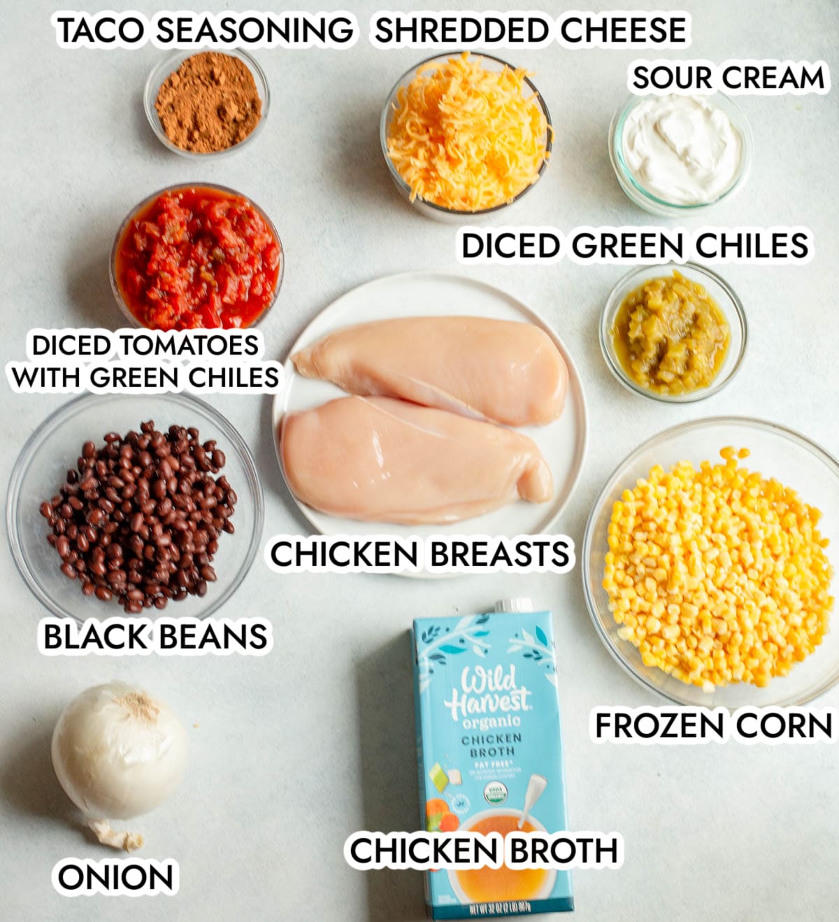 Ingredients in Creamy Chicken Tortilla Soup with a gray background. 