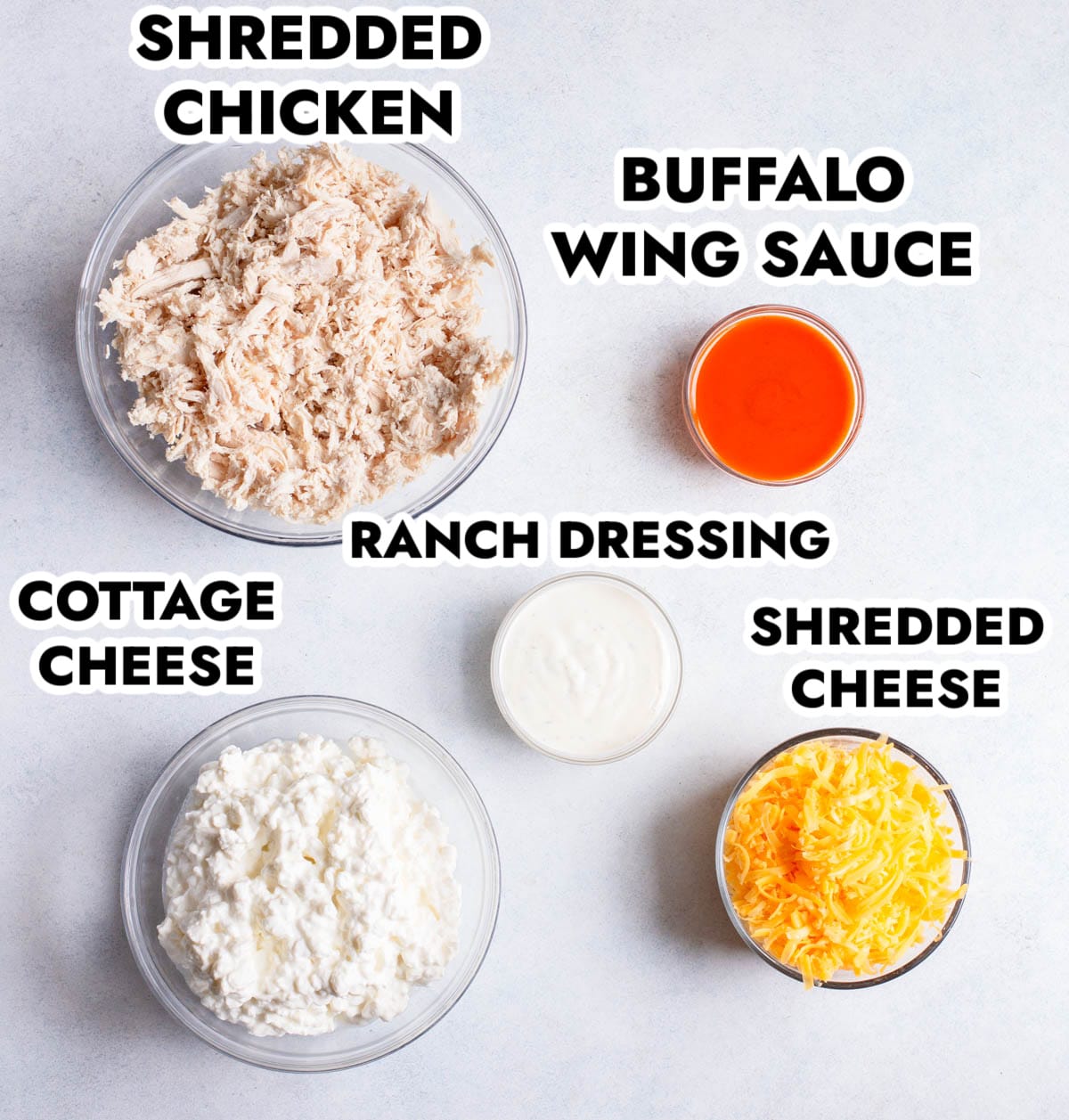 Ingredients in High Protein Buffalo Chicken Dip on a gray background.