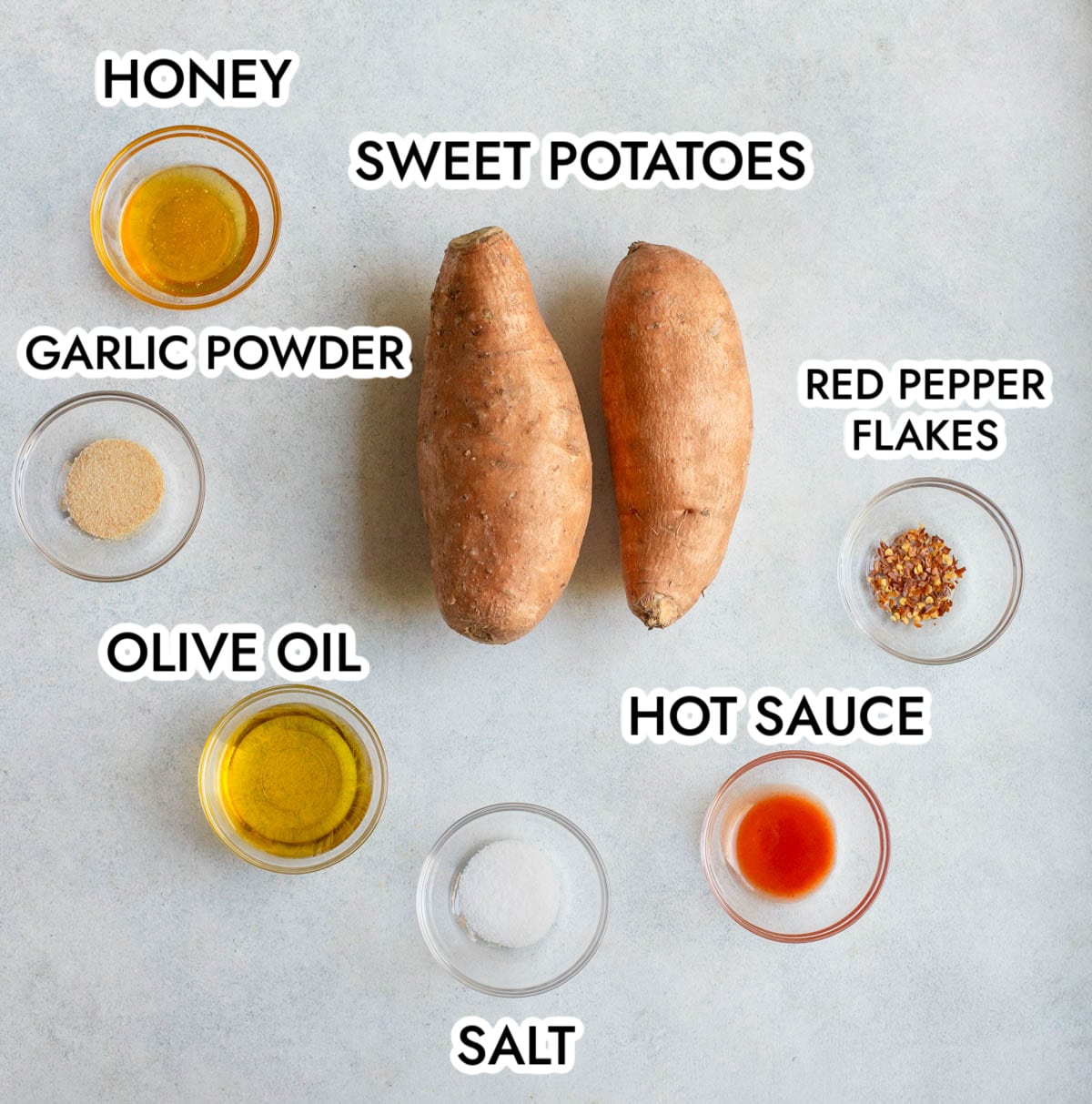 Ingredients in Hot Honey Sweet Potatoes on a gray background.