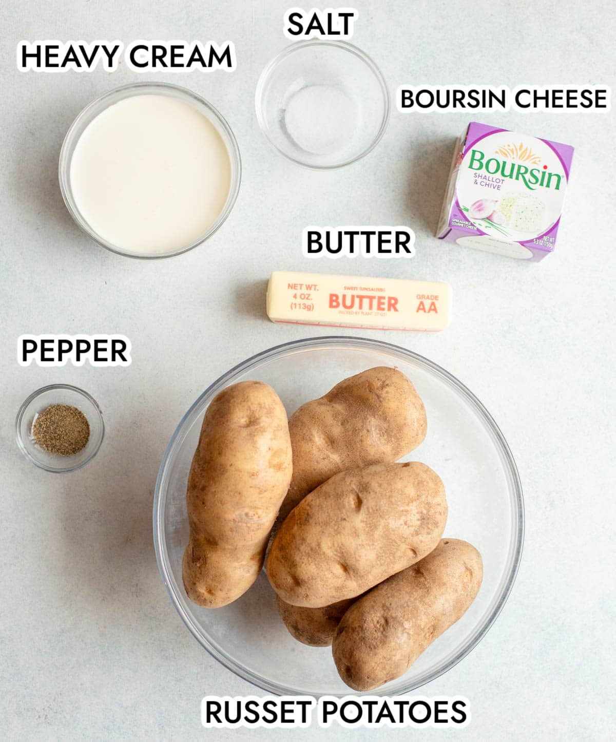 Ingredients for Boursin Mashed Potatoes on a gray background. 