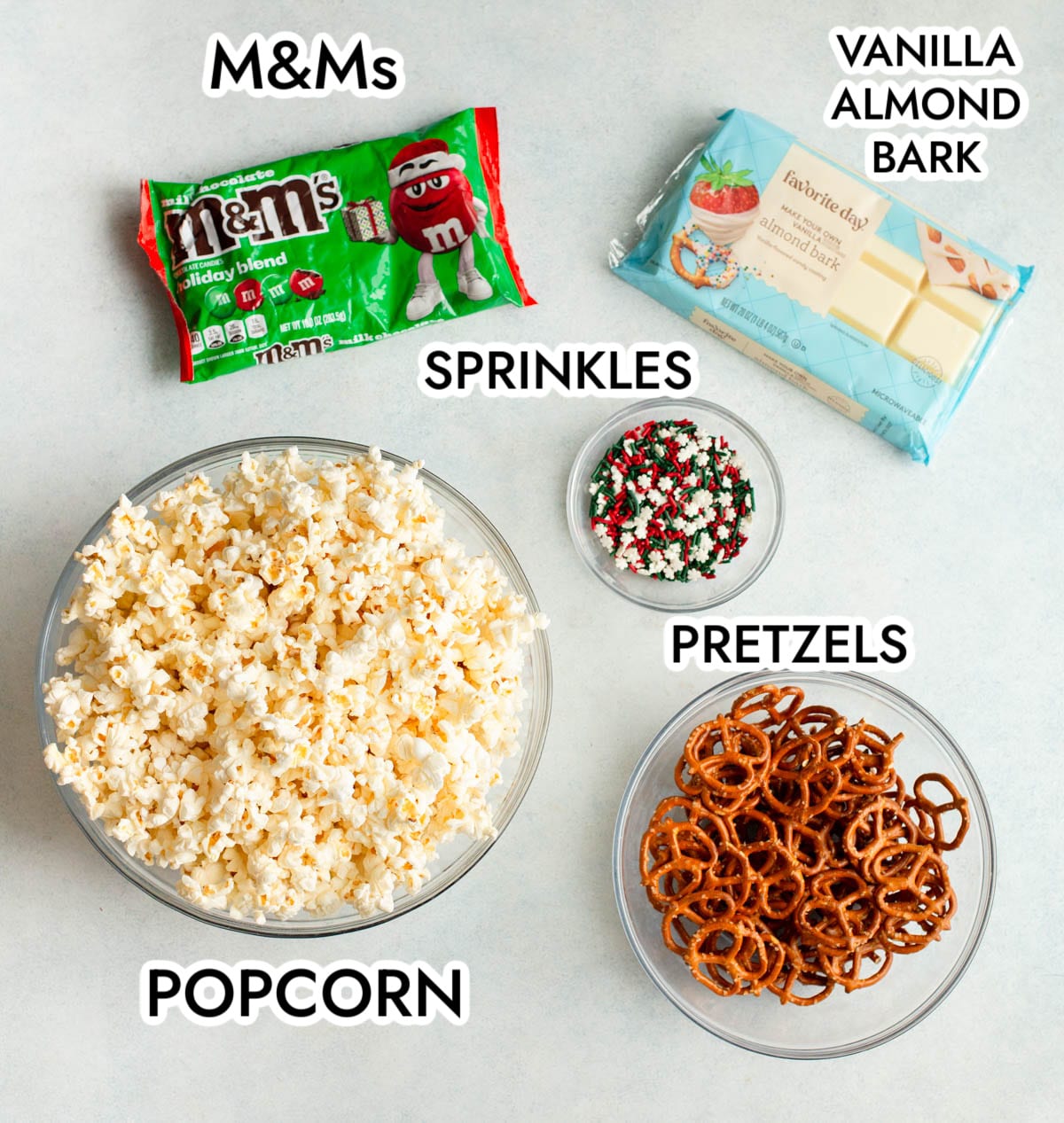 Ingredients in Christmas Popcorn on a gray background with black text.