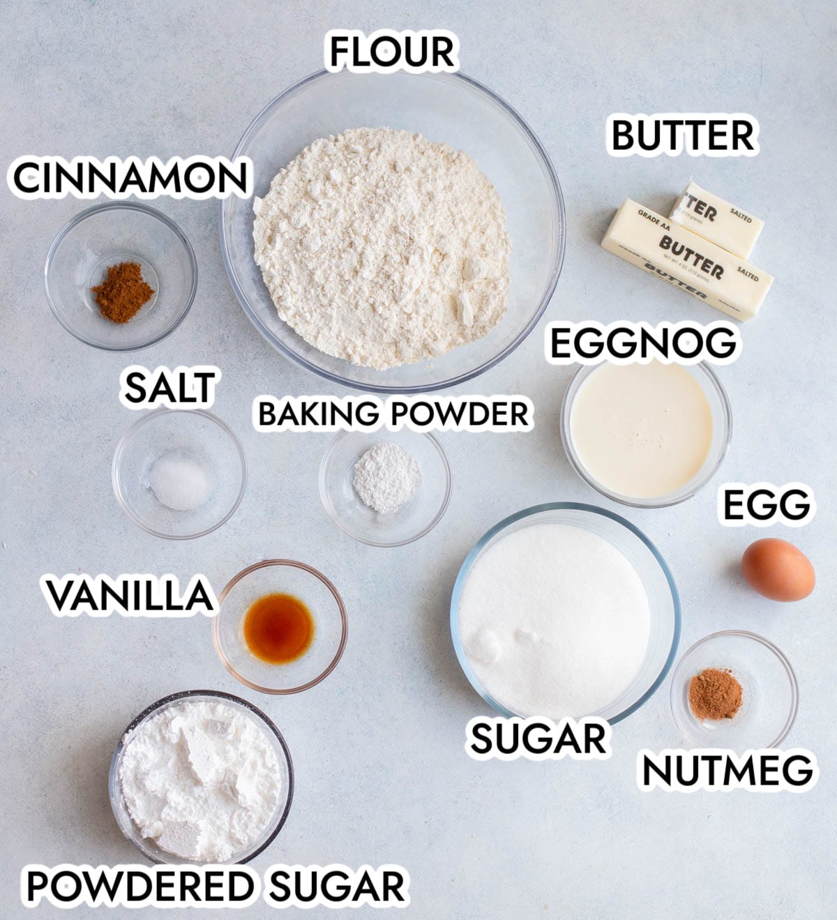 Ingredients in Eggnog Cookies on a gray background with black text. 